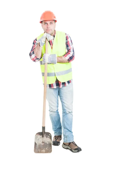 Thoughtful builder resting and holding shovel — Stock Photo, Image
