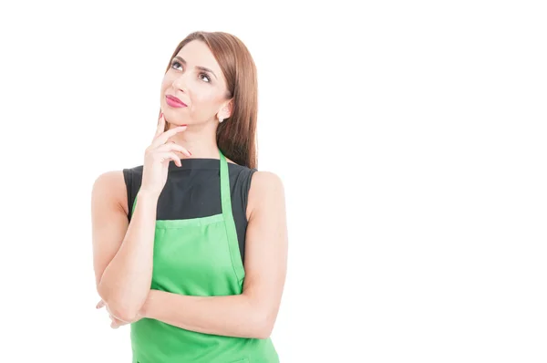 Gorgeous pensive employee with green apron — Stock Photo, Image
