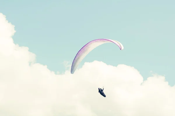 Paraglider flying into the white clouds — Stock Photo, Image
