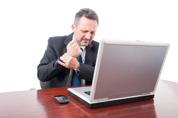 Stressed businessman having medical problem on wrist — Stock Photo, Image