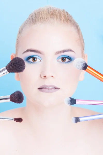Portrait of beauty make-up with different kinds of brushes