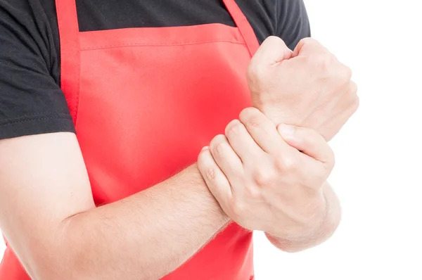 Closeup of supermarket employee holding wrist — Stock Photo, Image