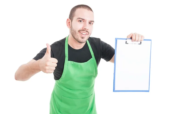 Male supermarket employee making thumb up gesture holding clipbo — Stock Photo, Image