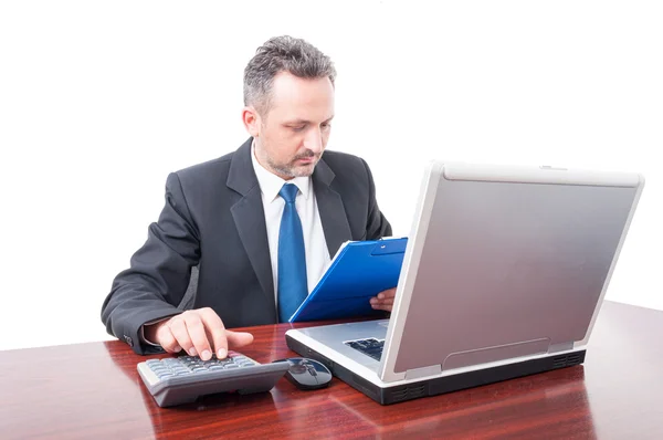 Man at office holding clipboard and calculating — Stock Photo, Image