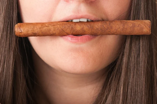 Woman holding a cigar between her teeth — Stock Photo, Image