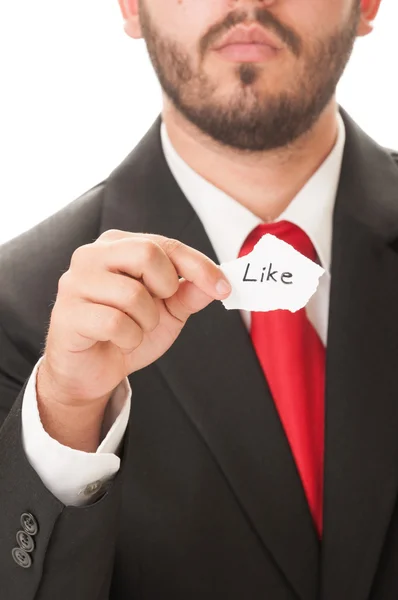 Elegant man holding a paper saying Like — Stock Photo, Image