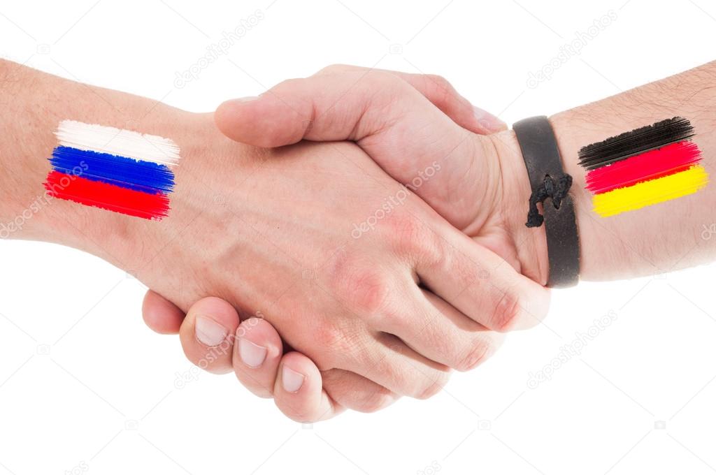 Russia and Germany hands shaking with flags