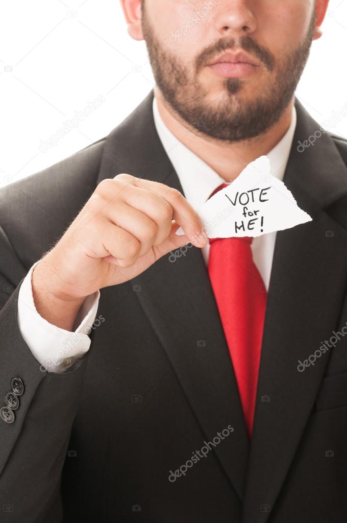 Politician holding a piece of paper saying Vote for Me
