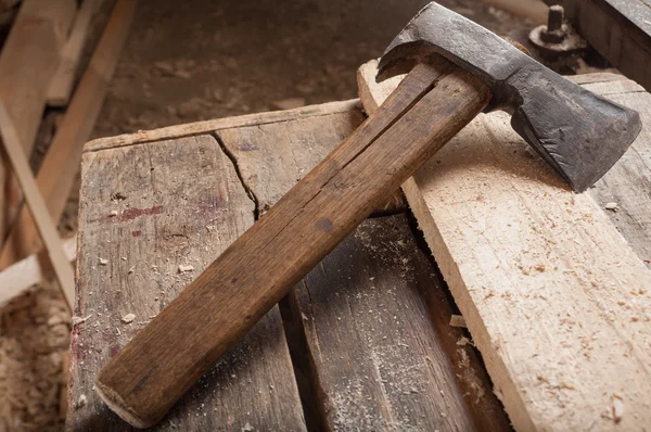 Old ax or hatchet on a piece of wood — Stock Photo, Image