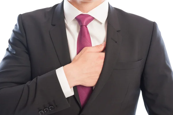 Elegant male model reaching his interior suit pocket — Stock Photo, Image