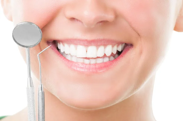 Closeup of perfect smile and dentist tools — Stock Photo, Image