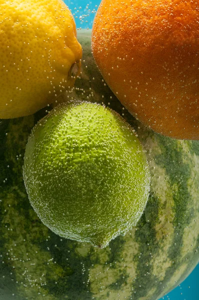 Fruits in water with bubbles — Stock Photo, Image