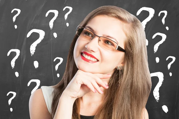 Woman and question marks arround her — Stock Photo, Image