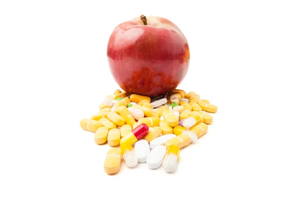 Red apple on pills — Stock Photo, Image