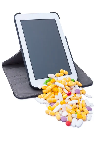 Colored pills coming from wireless tablet — Stock Photo, Image