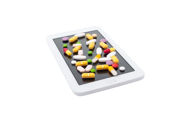Colored pills on touch screen — Stock Photo, Image