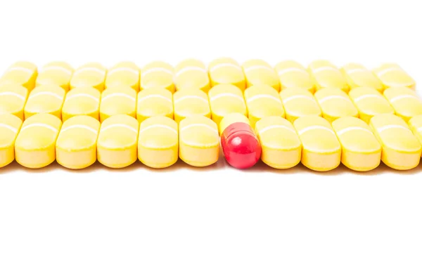 Pill standing out from the crowd of other pills — Stock Photo, Image