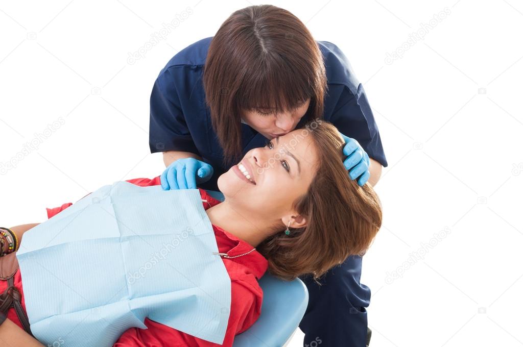 Dentist woman kissing female patient
