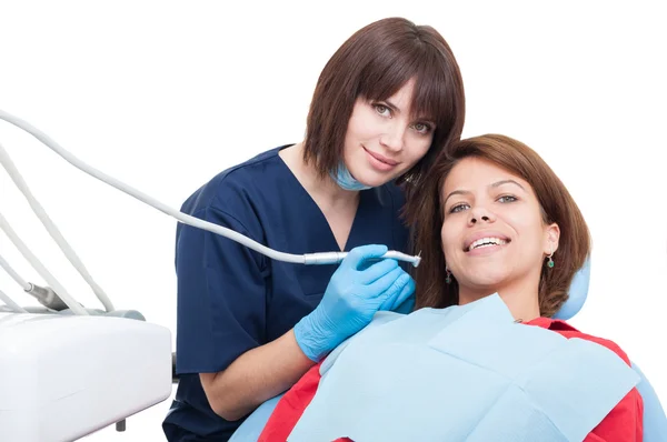 Female dentist doctor and smiling woman patient — Stock Photo, Image