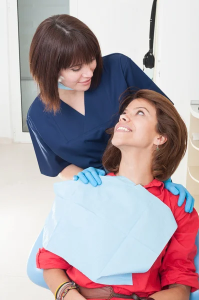 Dentist woman taking good care on her patient — Stock Photo, Image