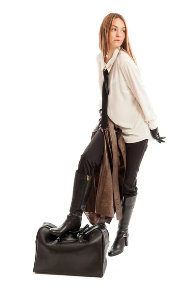 Female model stepping on black leather bag — Stock Photo, Image
