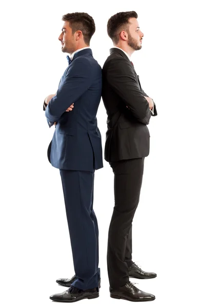 Competitive business men standing back to back — Stock Photo, Image