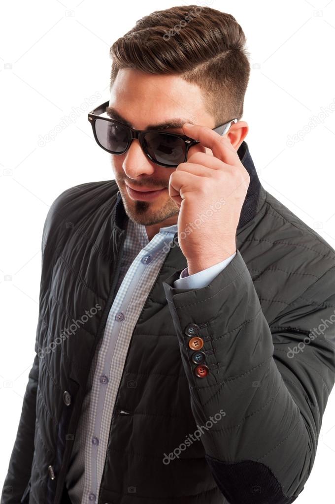 Business man wearing casual elegant holding his sunglasses