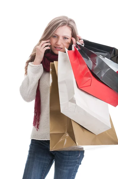Serious shopping girl talking on smartphone — Stock Photo, Image