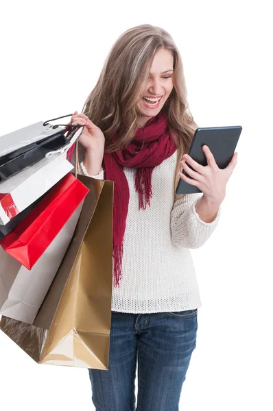 Shopping girl checking her wireless tablet — Stock Photo, Image