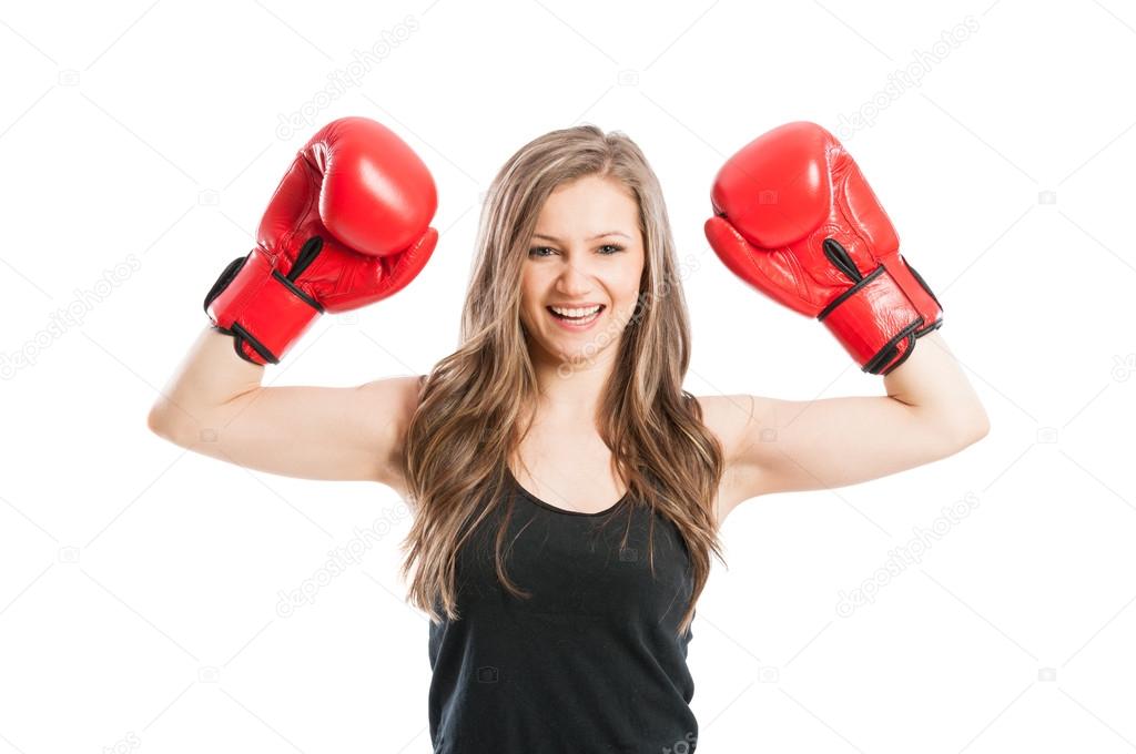 Beautiful and young boxer female raising arms up