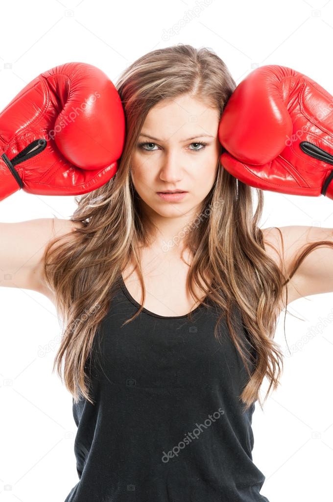 Portrait of a beautiful female wearing boxing gloves