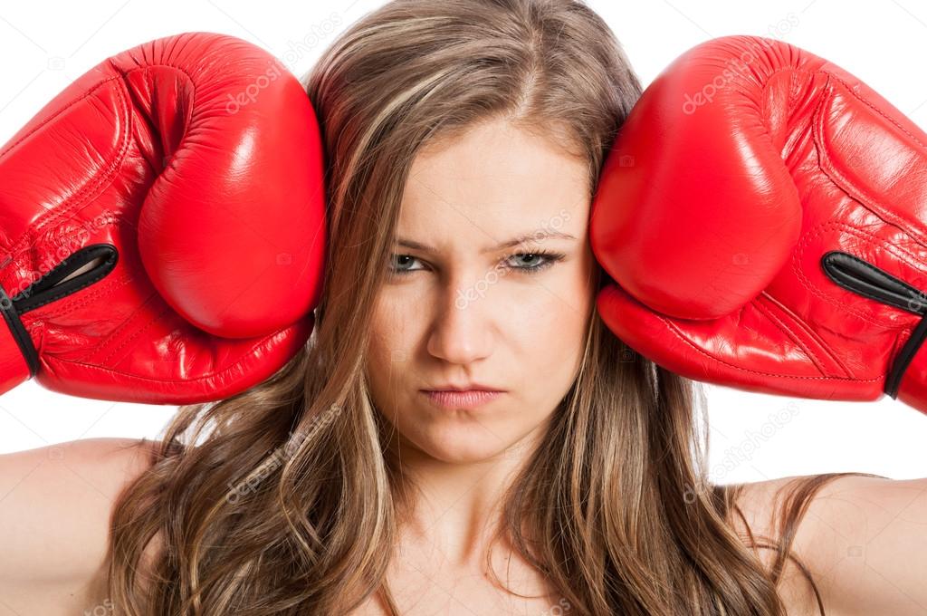 Beautiful female model with boxing gloves and serious face