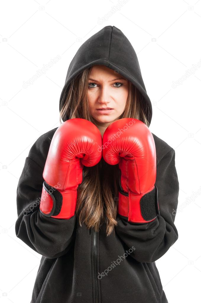 Young female model wearing red boxing gloves and black hoodie