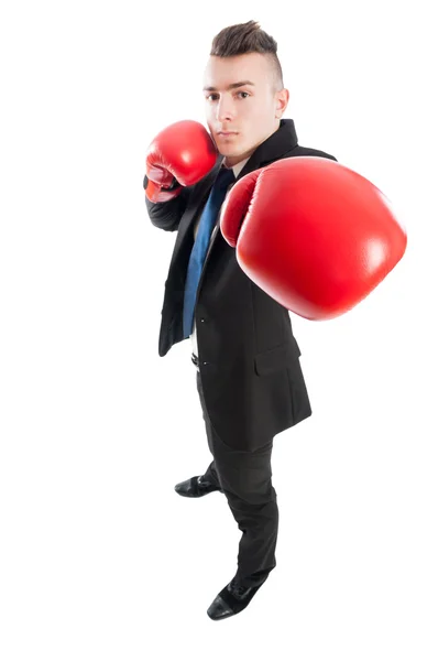 Hombre de negocios golpeando la cámara con guantes de boxeo —  Fotos de Stock