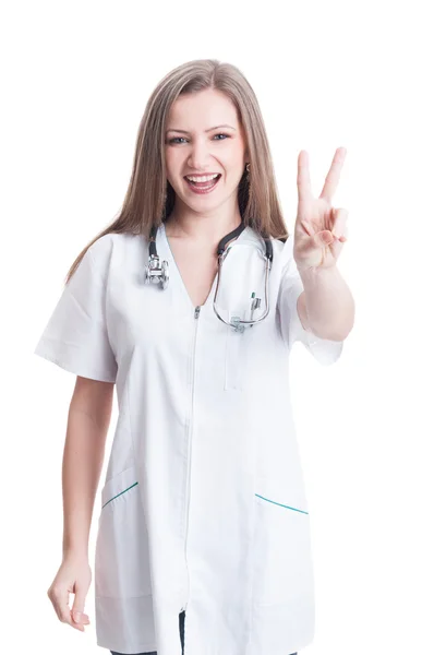 Woman doctor showing peace or victory gesture — Stock Photo, Image