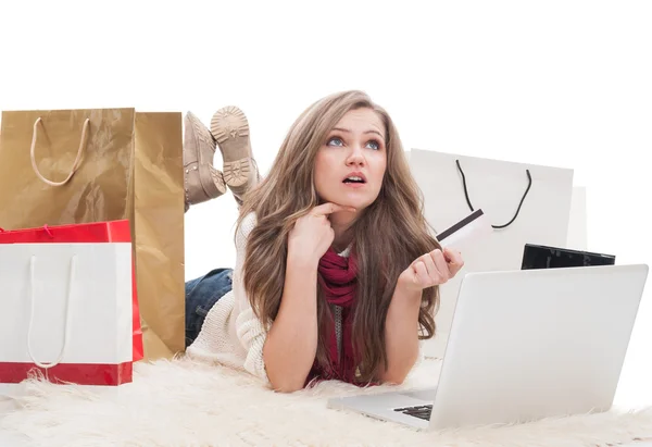 Shopping female holding card and thinking — Stock Photo, Image