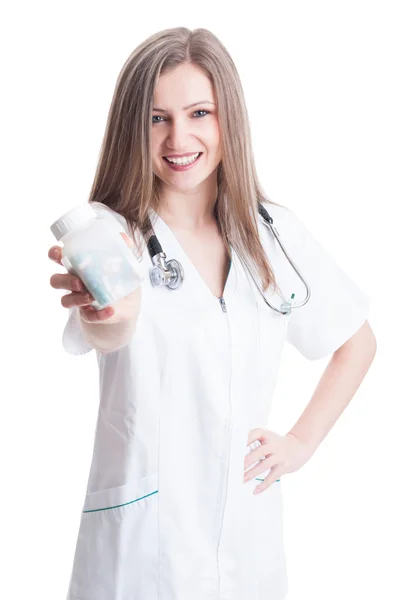 Friendly female doctor holding bottle of pills — Stock Photo, Image