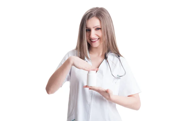 Young female doctor holding bottle of medicine — Stock Photo, Image