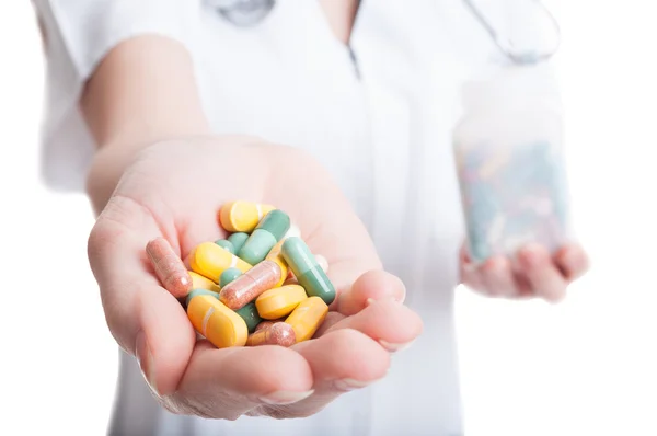 Closeup with woman hand holding natural pills and vitamins — Stock Photo, Image