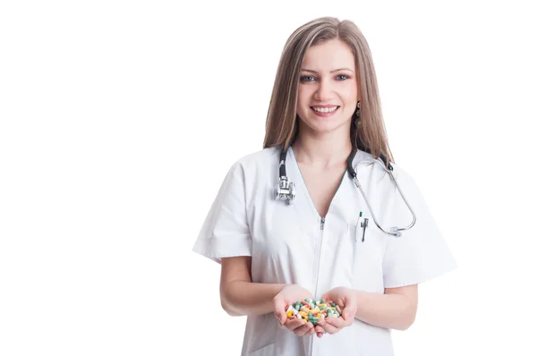 Woman or female doctor holding pills with both hands — Stock Photo, Image