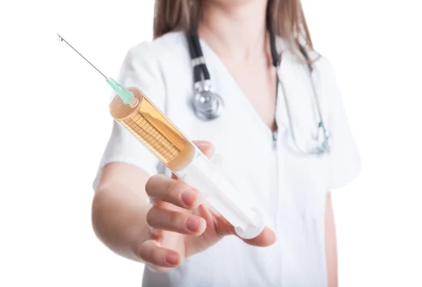Woman doctor showing a syringe — Stock Photo, Image