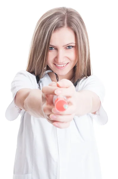 Cute woman doctor ponting a syringe to the camera — Stock Photo, Image