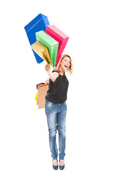 Feliz mujer de compras tirar bolsas de compras —  Fotos de Stock