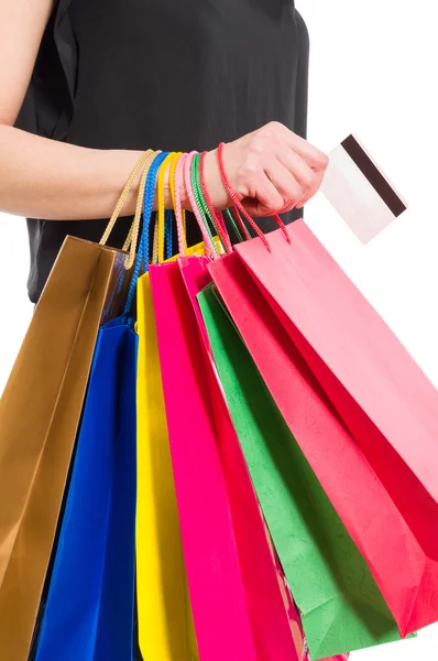 Woman hand holding shopping bags and credit or debit card — Stock Photo, Image