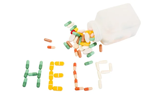 Word gemaakt van verschillende pillen helpen — Stockfoto