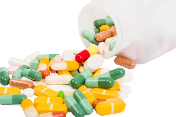 Closeup rozlité pilulek a láhev — Stock fotografie