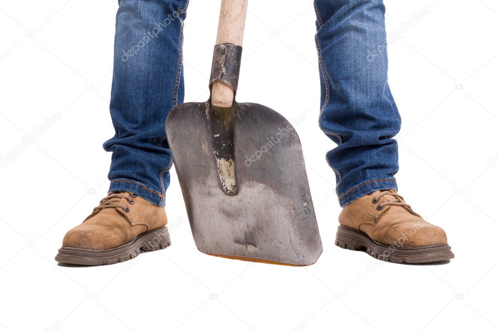 Builder feet with a shovel between