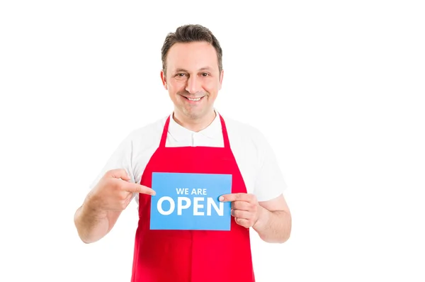 Friendly supermarket employee holding open sign — Stock Photo, Image