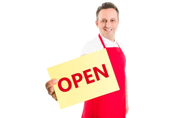 Friendly supermarket employee holding open sign — Stock Photo, Image