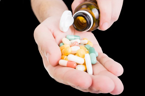 Pouring pills in hand — Stock Photo, Image